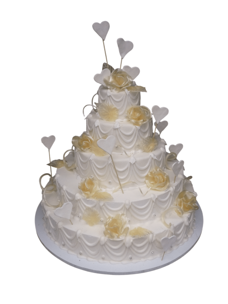 Gâteau de mariage à plusieurs niveaux, décoré de fleurs et de cœurs en sucre.